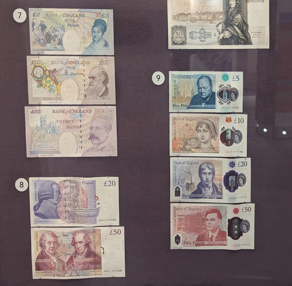 A couple of sets of banknotes from different time periods. The most recent ones feature Winston Churchill, Jane Austen, JMW Turner, and Alan Turing.